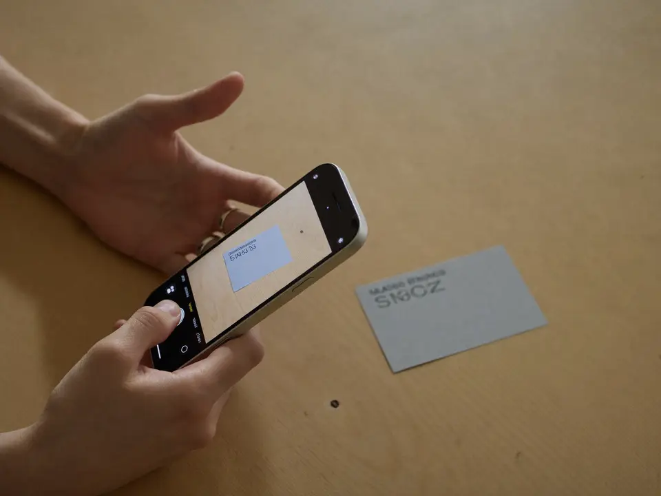 Hands scanning an ID card with a phone